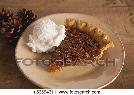 Stock Image - USA, Illinois, Metamora, Close up of slice of cake and ice cream on plate. Fotosearch