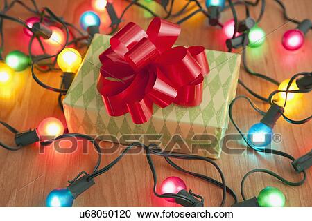 USA, Illinois, Metamora, Close up of Christmas present and Christmas lights View Large Photo Image Stock Image - USA, Illinois, Metamora, Close up of Christmas present and Christmas lights. Fotosearch