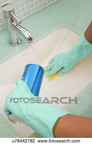USA, Illinois, Metamora, Close-up of woman in rubber gloves cleaning bathroom sink View Large Photo Image Stock Image - USA, Illinois, Metamora, Close-up of woman in rubber gloves cleaning bathroom sink. Fotosearch