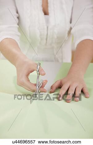 USA, Illinois, Metamora, close-up of woman cutting textile View Large Photo Image Stock Photo - USA, Illinois, Metamora, close-up of woman cutting textile. Fotosearch