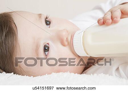 USA, Illinois, Metamora, close-up of baby boy (12-17 months) drinking milk from bottle View Large Photo Image Stock Photo - USA, Illinois, Metamora, close-up of baby boy (12-17 months) drinking milk from bottle. Fotosearch