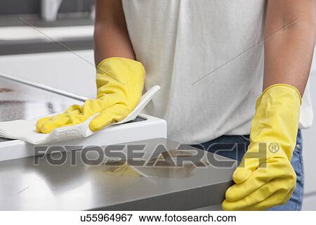 USA, Illinois, Metamora, Close-up of woman in rubber gloves cleaning kitchen counter, mid section View Large Photo Image Stock Photo - USA, Illinois, Metamora, Close-up of woman in rubber gloves cleaning kitchen counter, mid section. Fotosearch