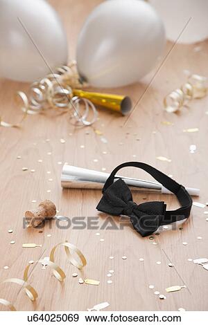 Stock Photo - USA, Illinois, Metamora, close up of new year's party decorations with bow tie and balloons. Fotosearch