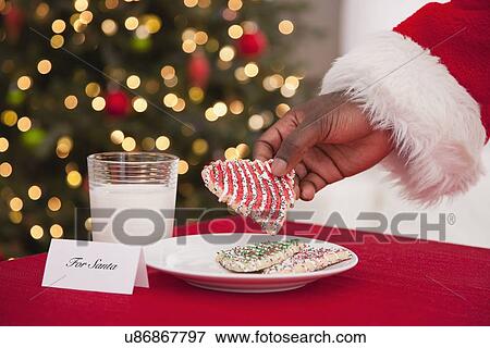 USA, Illinois, Metamora, Close up of hand of Santa Claus holding cookie View Large Photo Image Stock Photo - USA, Illinois, Metamora, Close up of hand of Santa Claus holding cookie. Fotosearch