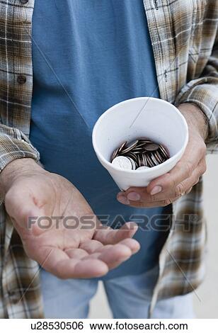 Stock Photograph - USA, Illinois, Metamora, Close-up of man begging for money. Fotosearch