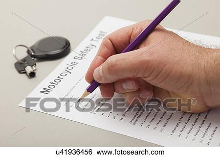 USA, Illinois, Metamora, Close up of man's hand filling in motorcycle safety test form View Large Photo Image Stock Photograph - USA, Illinois, Metamora, Close up of man's hand filling in motorcycle safety test form. Fotosearch
