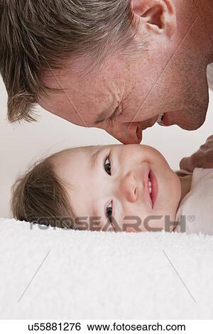 USA, Illinois, Metamora, close-up of father playing with baby boy (12-17 months) View Large Photo Image Stock Photograph - USA, Illinois, Metamora, close-up of father playing with baby boy (12-17 months). Fotosearch