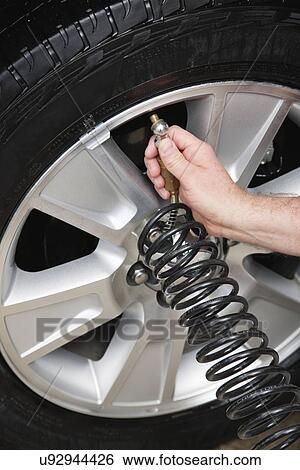 USA, Illinois, Metamora, Close-up of man's hands inflating car's tire View Large Photo Image Stock Photograph - USA, Illinois, Metamora, Close-up of man's hands inflating car's tire. Fotosearch