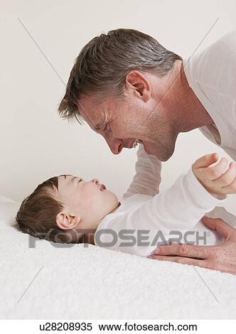 USA, Illinois, Metamora, close-up of father playing with baby boy (12-17 months) View Large Photo Image Stock Photography - USA, Illinois, Metamora, close-up of father playing with baby boy (12-17 months). Fotosearch