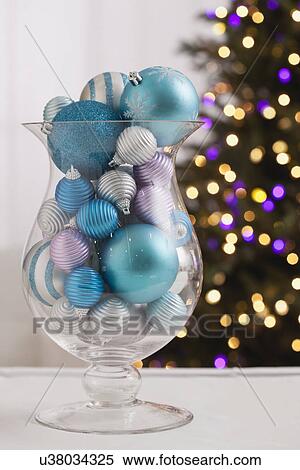 Stock Photography - USA, Illinois, Metamora, Close up of various Christmas ornaments in vase. Fotosearch