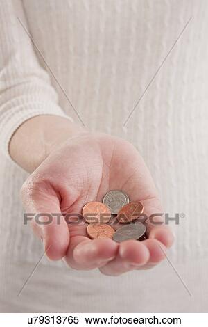 Stock Photography - USA, Illinois, Metamora, close-up of woman's hand holding pennies. Fotosearch