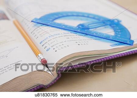 USA, Illinois, Metamora, Close-up of pencil and protractor on open book View Large Photo Image Stock Photography - USA, Illinois, Metamora, Close-up of pencil and protractor on open book. Fotosearch