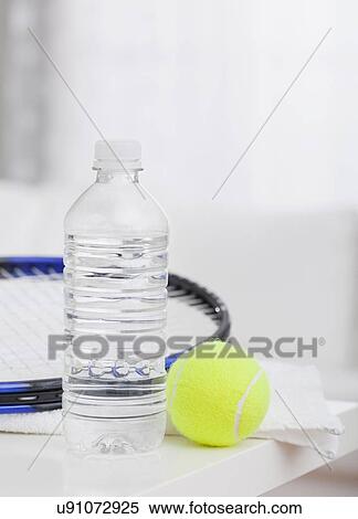 USA, Illinois, Metamora, Close up of tennis rocket, tennis ball and water bottle on table View Large Photo Image Stock Photography - USA, Illinois, Metamora, Close up of tennis rocket, tennis ball and water bottle on table. Fotosearch