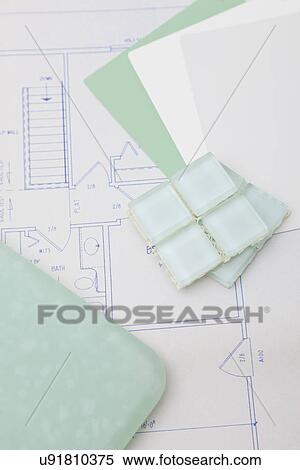 Stock Photography - USA, Illinois, Metamora, close up of tile lying on blueprints. Fotosearch