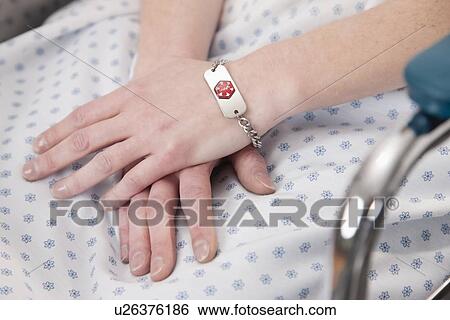 Stock Photograph - USA, Illinois, Metamora, Close-up on patient's hands. Fotosearch