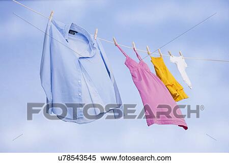 Stock Photography - USA, Illinois, Metamora, clothing in various sizes drying on clothesline. Fotosearch