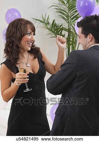 Stock Photography - USA, Illinois, Metamora, Couple dancing at New Year's Eve party. Fotosearch