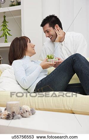 USA, Illinois, Metamora, Couple opening presents View Large Photo Image Stock Image - USA, Illinois, Metamora, Couple opening presents. Fotosearch