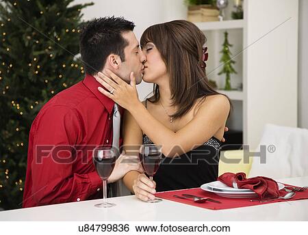 Stock Photograph - USA, Illinois, Metamora, Couple drinking wine and kissing. Fotosearch