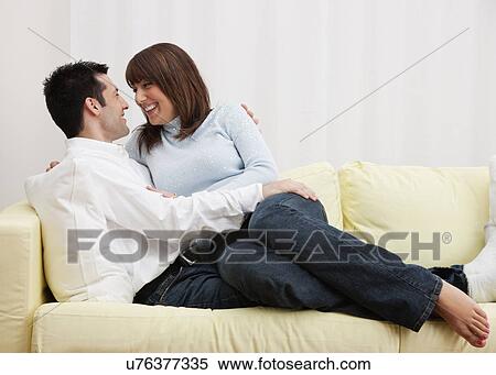 USA, Illinois, Metamora, Couple embracing on sofa View Large Photo Image Stock Photography - USA, Illinois, Metamora, Couple embracing on sofa. Fotosearch