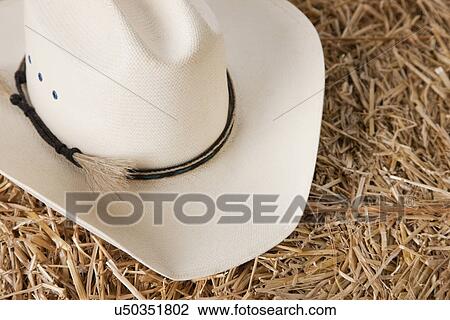 Stock Image - USA, Illinois, Metamora, Cowboy hat on haystack. Fotosearch