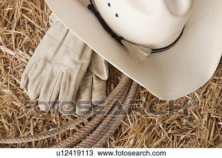 USA, Illinois, Metamora, Cowboy hat, lasso and gloves on haystack View Large Photo Image Stock Image - USA, Illinois, Metamora, Cowboy hat, lasso and gloves on haystack. Fotosearch