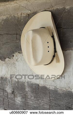 Stock Photo - USA, Illinois, Metamora, Cowboy hat hanging outdoors. Fotosearch