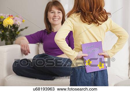 USA, Illinois, Metamora, Daughter (4-5) hiding greeting card for Mother's day behind her back View Large Photo Image Stock Image - USA, Illinois, Metamora, Daughter (4-5) hiding greeting card for Mother's day behind her back. Fotosearch