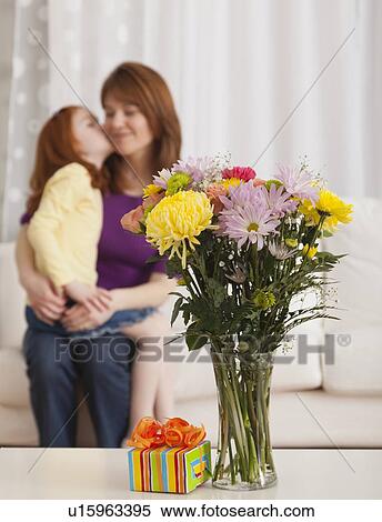 Stock Photography - USA, Illinois, Metamora, Daughter (4-5) and mother celebrating Mother's day. Fotosearch