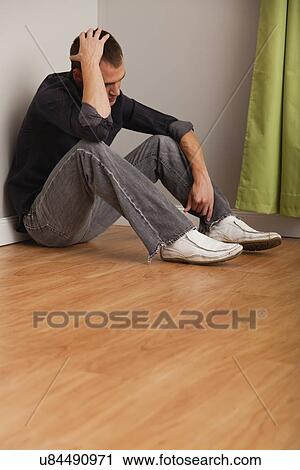 USA, Illinois, Metamora, Depressed man sitting on floor in empty room View Large Photo Image Stock Image - USA, Illinois, Metamora, Depressed man sitting on floor in empty room. Fotosearch