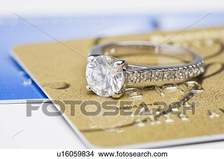 USA, Illinois, Metamora, Diamond ring on credit cards View Large Photo Image Picture - USA, Illinois, Metamora, Diamond ring on credit cards. Fotosearch