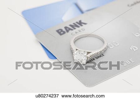 Stock Photo - USA, Illinois, Metamora, Diamond ring on credit cards. Fotosearch