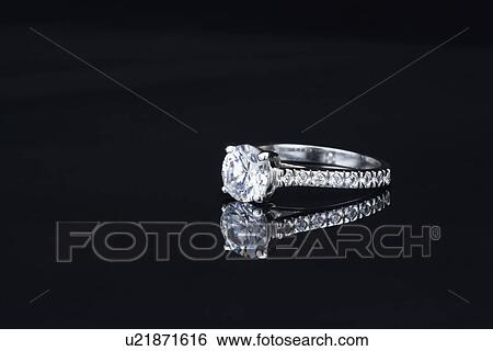 Stock Photograph - USA, Illinois, Metamora, Diamond ring on black background. Fotosearch
