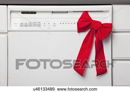 Stock Photo - USA, Illinois, Metamora, Dishwasher Christmas gift with bow. Fotosearch