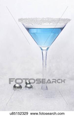 Stock Photo - USA, Illinois, Metamora, drink in martini glass on snow. Fotosearch
