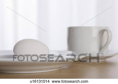 USA, Illinois, Metamora, Egg on plate with coffee cup View Large Photo Image Picture - USA, Illinois, Metamora, Egg on plate with coffee cup. Fotosearch