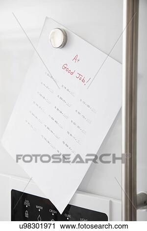 Stock Image - USA, Illinois, Metamora, Exam result pinned to fridge door. Fotosearch