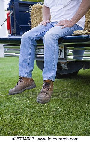 USA, Illinois, Metamora, Farmer sitting on pickup truck View Large Photo Image Stock Image - USA, Illinois, Metamora, Farmer sitting on pickup truck. Fotosearch