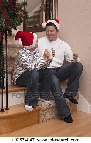 USA, Illinois, Metamora, father and son wearing santa hats View Large Photo Image Stock Photo - USA, Illinois, Metamora, father and son wearing santa hats. Fotosearch