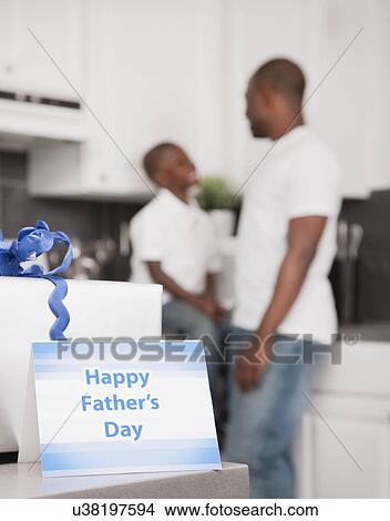 Picture - USA, Illinois, Metamora, Father's day gift and card, father and son (6-7) in background. Fotosearch