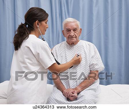 USA, Illinois, Metamora, Female doctor examining senior man sitting on hospital bed View Large Photo Image Stock Image - USA, Illinois, Metamora, Female doctor examining senior man sitting on hospital bed. Fotosearch