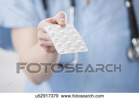 USA, Illinois, Metamora, Female doctor holding blister pack View Large Photo Image Stock Photo - USA, Illinois, Metamora, Female doctor holding blister pack. Fotosearch