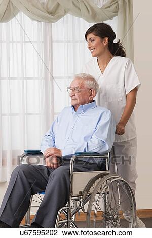 USA, Illinois, Metamora, Female nurse with senior man on wheelchair View Large Photo Image Stock Image - USA, Illinois, Metamora, Female nurse with senior man on wheelchair. Fotosearch
