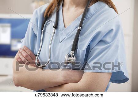 Stock Photo - USA, Illinois, Metamora, Female nurse with stethoscope. Fotosearch