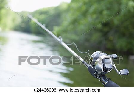 USA, Illinois, Metamora, Fishing pole over river View Large Photo Image Stock Photograph - USA, Illinois, Metamora, Fishing pole over river. Fotosearch