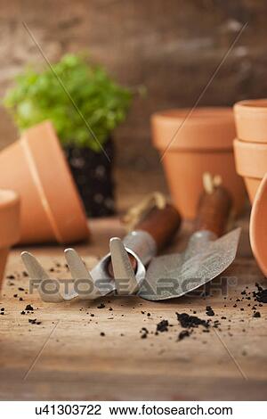 Stock Image - USA, Illinois, Metamora, Flower pots with gardening tools. Fotosearch