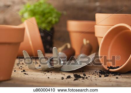 Stock Image - USA, Illinois, Metamora, Flower pots with gardening tools. Fotosearch
