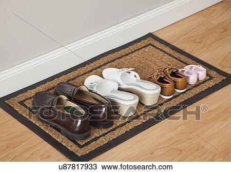 USA, Illinois, Metamora, four pairs of shoes on mat View Large Photo Image Stock Image - USA, Illinois, Metamora, four pairs of shoes on mat. Fotosearch