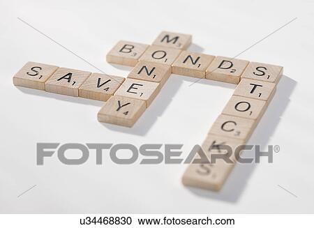 Stock Image - USA, Illinois, Metamora, Game pieces spelling out financial words. Fotosearch
