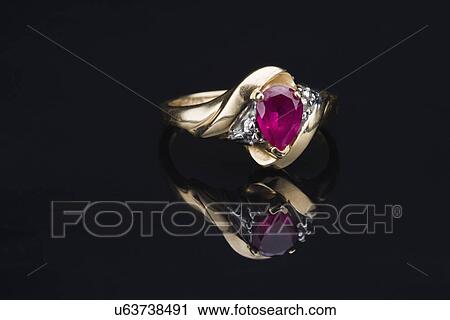 Stock Image - USA, Illinois, Metamora, Gemstone ring on black background. Fotosearch